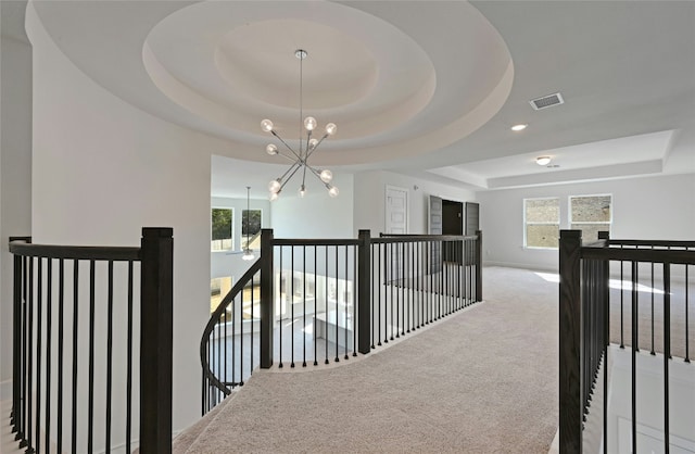 7701 Becasseau Dr, Austin, TX 78738 - hall with a raised ceiling, an upstairs landing, a chandelier, and carpet flooring