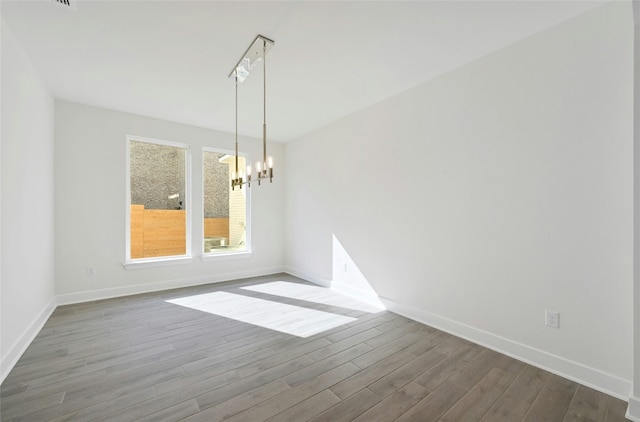 7701 Becasseau Dr, Austin, TX 78738 - unfurnished room with a chandelier and dark wood-type flooring