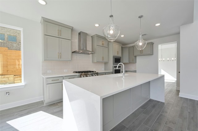 7701 Becasseau Dr, Austin, TX 78738 - kitchen with wall chimney exhaust hood, gray cabinets, stainless steel microwave, decorative backsplash, and recessed lighting