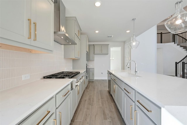 7701 Becasseau Dr, Austin, TX 78738 - kitchen with wall chimney exhaust hood, light wood-style flooring, light countertops, stainless steel appliances, and recessed lighting