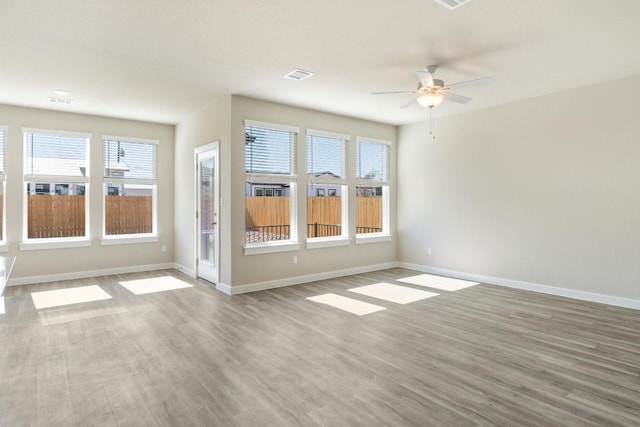 empty room featuring hardwood / wood-style flooring and ceiling fan