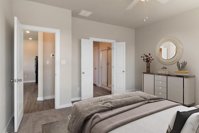 bedroom with black fridge, ceiling fan, and dark hardwood / wood-style floors