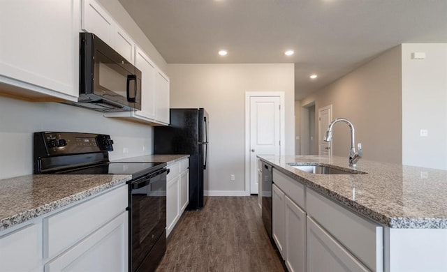 kitchen with a center island with sink, white cabinets, black appliances, sink, and dark hardwood / wood-style floors