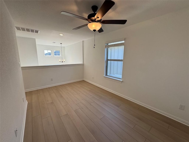 spare room with ceiling fan and light hardwood / wood-style flooring