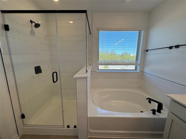 bathroom with shower with separate bathtub and vanity