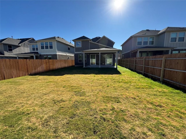 rear view of property with a lawn