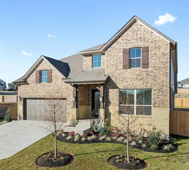 view of front of property featuring a garage and a front lawn