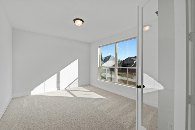 empty room featuring light colored carpet