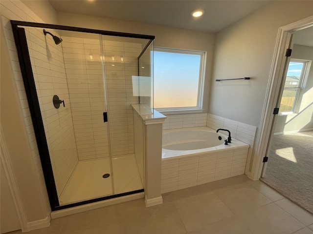 bathroom with separate shower and tub and tile patterned floors