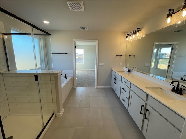 bathroom with tile patterned floors, vanity, a healthy amount of sunlight, and shower with separate bathtub