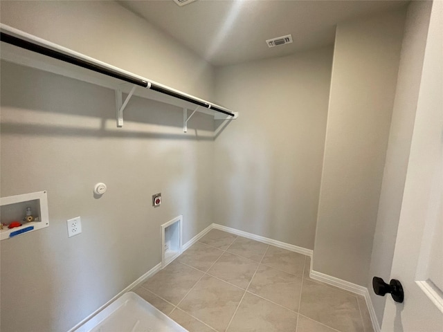 laundry area featuring light tile patterned floors, gas dryer hookup, washer hookup, and electric dryer hookup