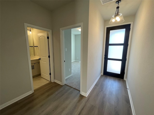 entrance foyer with a chandelier and light hardwood / wood-style floors