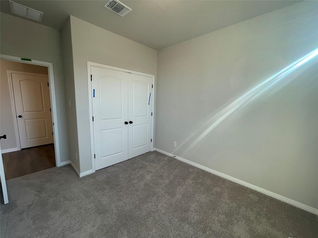 unfurnished bedroom featuring a closet and carpet floors