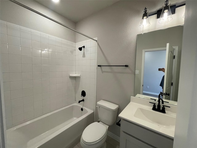 full bathroom featuring toilet, tiled shower / bath, and vanity