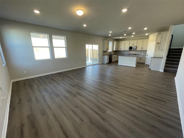 unfurnished living room featuring dark hardwood / wood-style flooring