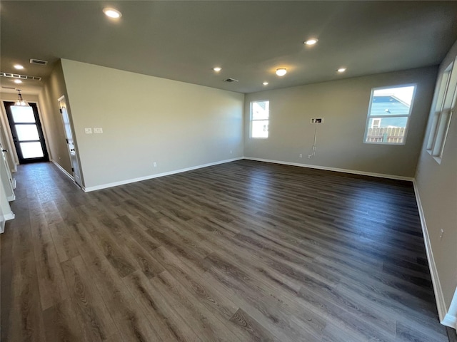 unfurnished room with dark wood-type flooring