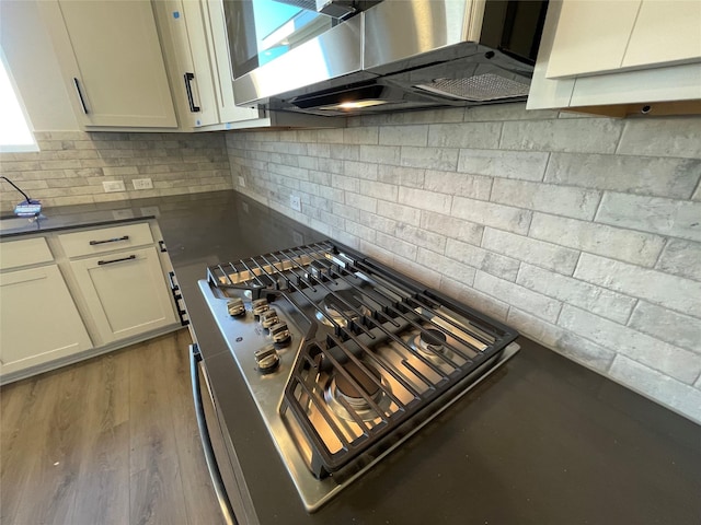 kitchen featuring decorative backsplash and dark hardwood / wood-style floors