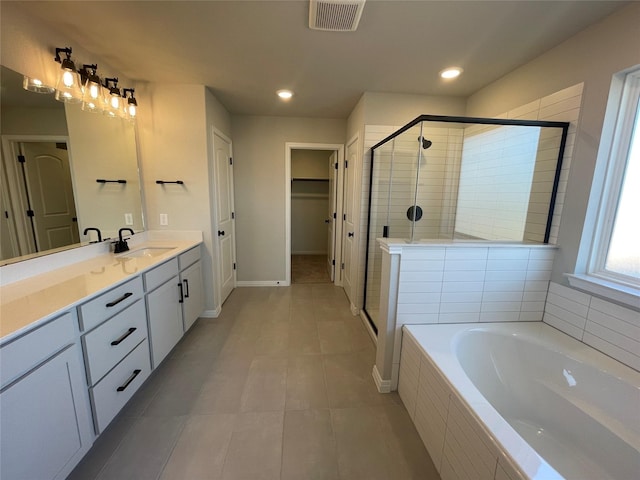 bathroom featuring vanity, tile patterned flooring, and plus walk in shower