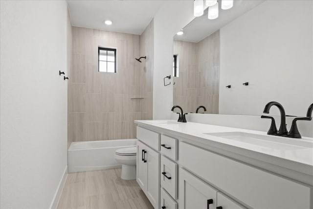 full bathroom featuring vanity, toilet, and tiled shower / bath