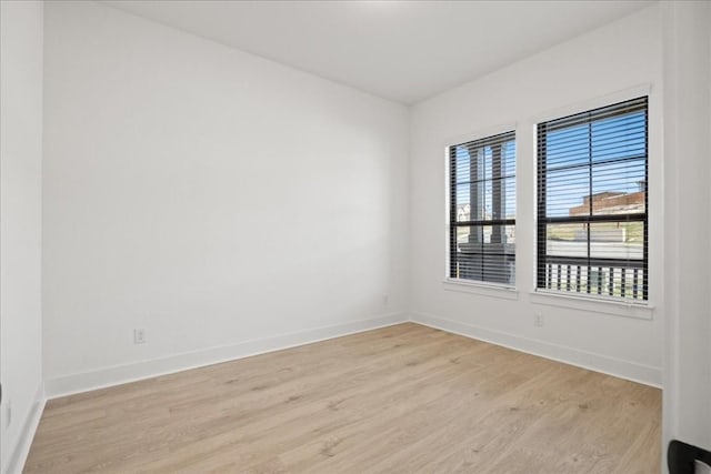 empty room with light hardwood / wood-style flooring