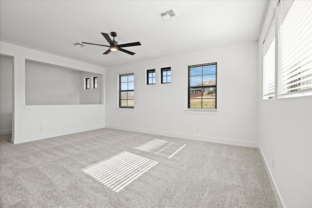 carpeted spare room with ceiling fan