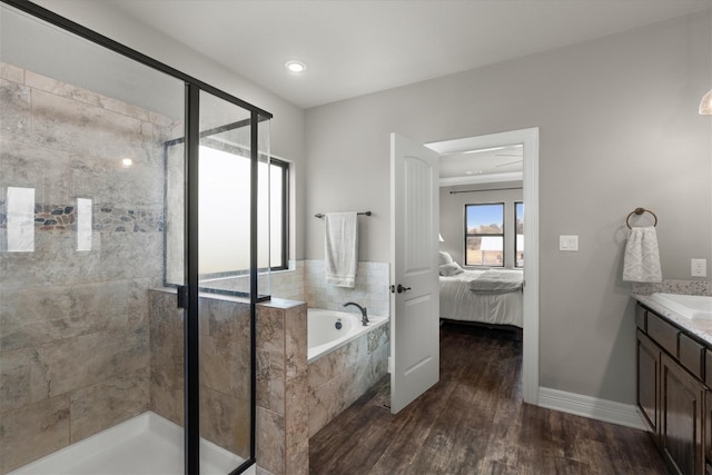 bathroom with vanity, hardwood / wood-style flooring, and separate shower and tub