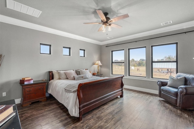 bedroom with ornamental molding, ceiling fan, and dark hardwood / wood-style floors