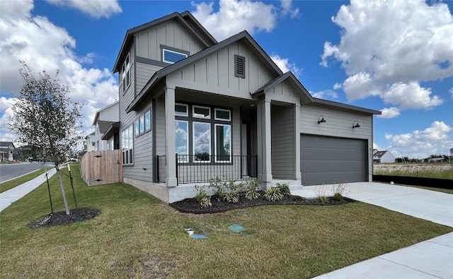 view of front of property with a garage, a front yard, and a porch