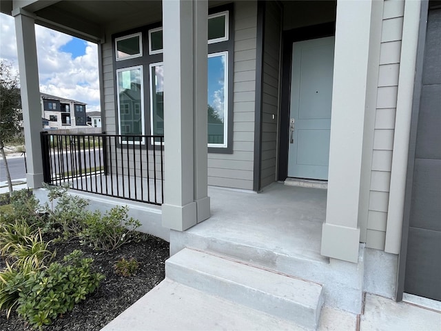 view of exterior entry with a porch