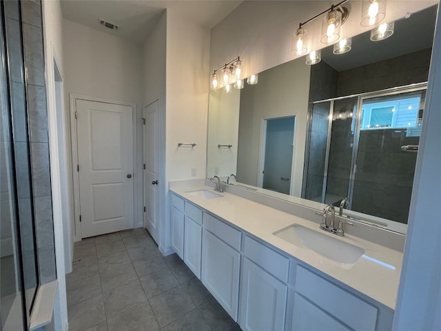 bathroom featuring tile patterned flooring, vanity, and an enclosed shower