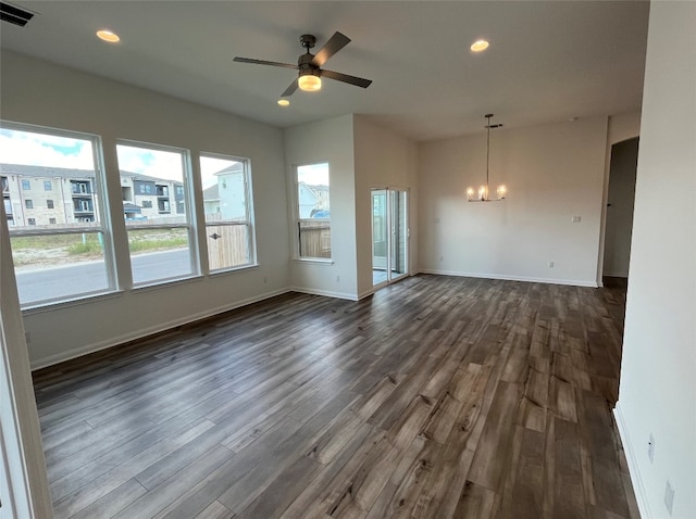 unfurnished living room featuring dark wood-type flooring and ceiling fan with notable chandelier