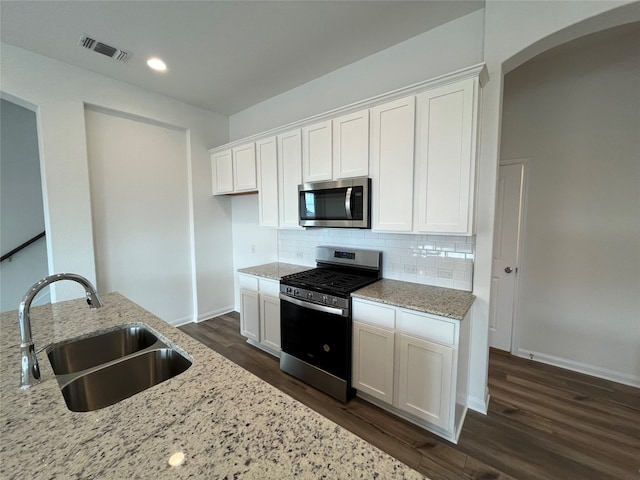 kitchen featuring white cabinets, light stone countertops, and appliances with stainless steel finishes