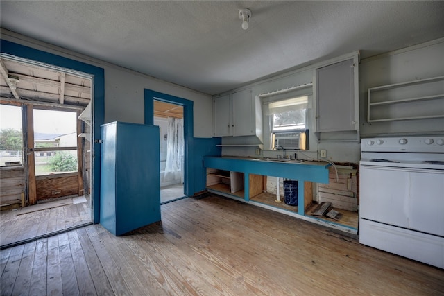 kitchen featuring white range with electric stovetop, cooling unit, light hardwood / wood-style floors, a textured ceiling, and white cabinets