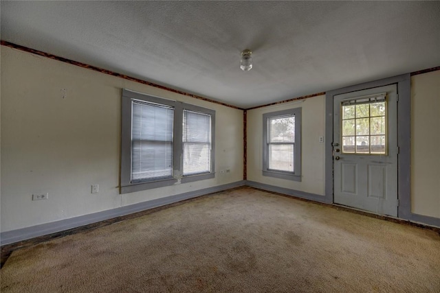 207 S Waco St, Giddings, TX 78942 - carpeted empty room with baseboards and a textured ceiling