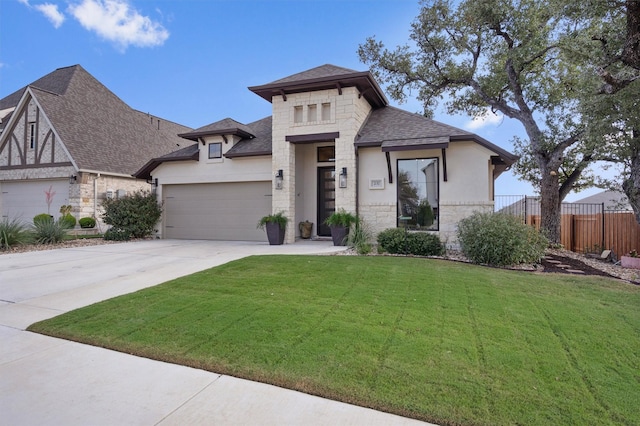 view of front of home featuring a garage and a front lawn