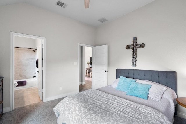 carpeted bedroom with ensuite bathroom and ceiling fan