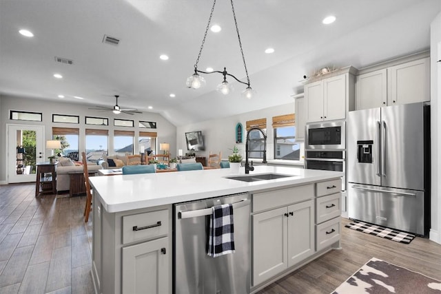 kitchen with white cabinets, sink, an island with sink, and stainless steel appliances