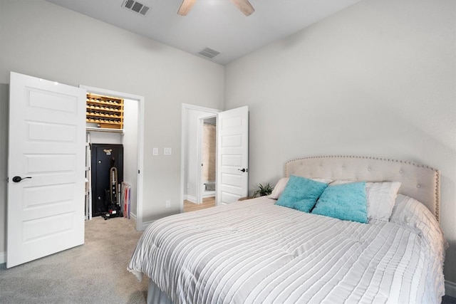 bedroom featuring light colored carpet and ceiling fan