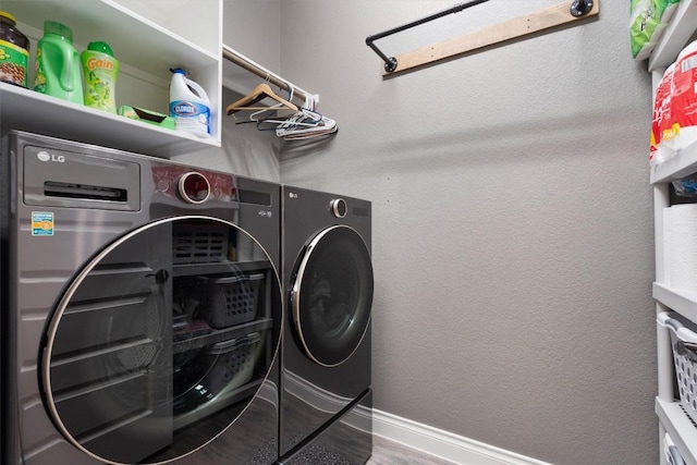 clothes washing area featuring independent washer and dryer