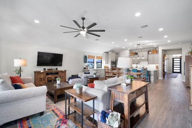 living room featuring ceiling fan and hardwood / wood-style floors