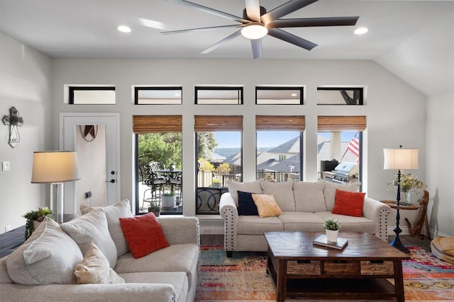 living room featuring hardwood / wood-style flooring, ceiling fan, and lofted ceiling