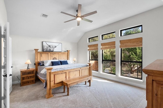 bedroom with ceiling fan, lofted ceiling, and light carpet