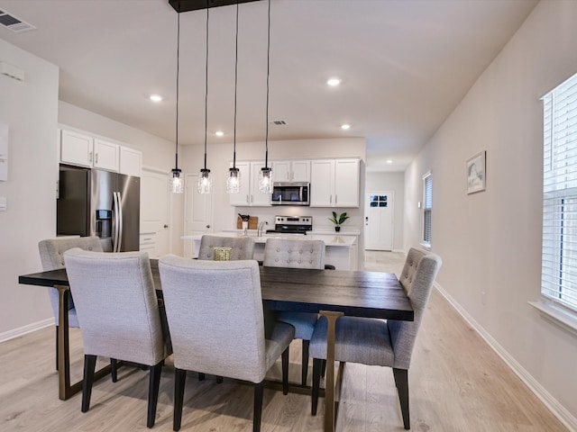 dining area featuring light wood-type flooring