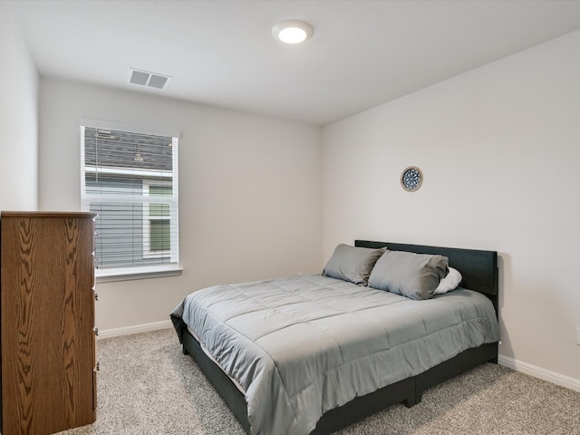 bedroom with light colored carpet