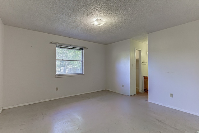 spare room featuring a textured ceiling