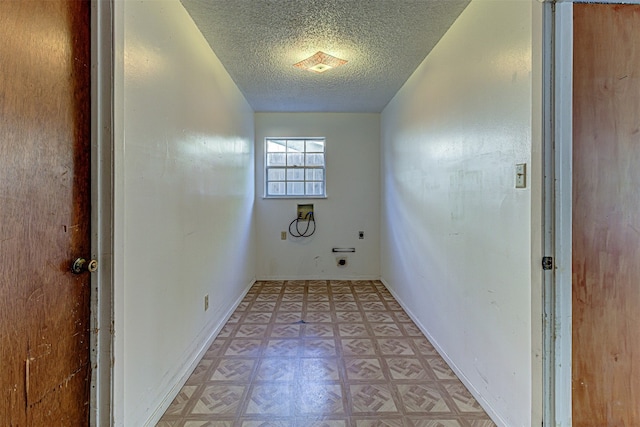 washroom with electric dryer hookup, a textured ceiling, and washer hookup