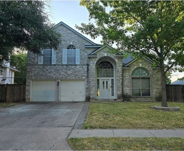 view of front of home with a garage and a front yard