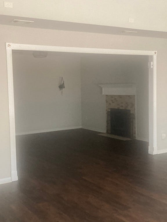 unfurnished living room with dark hardwood / wood-style floors