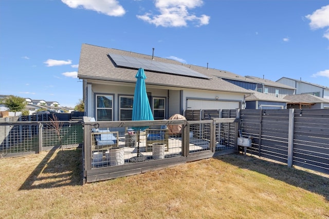 rear view of house with a patio area, solar panels, and a yard