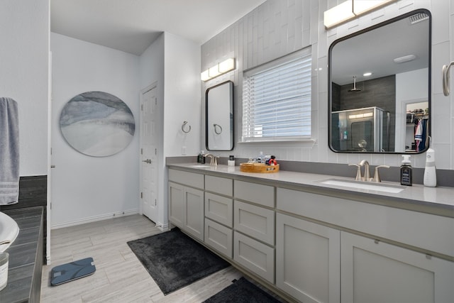 bathroom featuring walk in shower, vanity, hardwood / wood-style floors, and tile walls